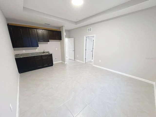 13014 Willow Grove Dr, Riverview, FL 33579 - kitchen with a raised ceiling, baseboards, light tile patterned floors, and a sink