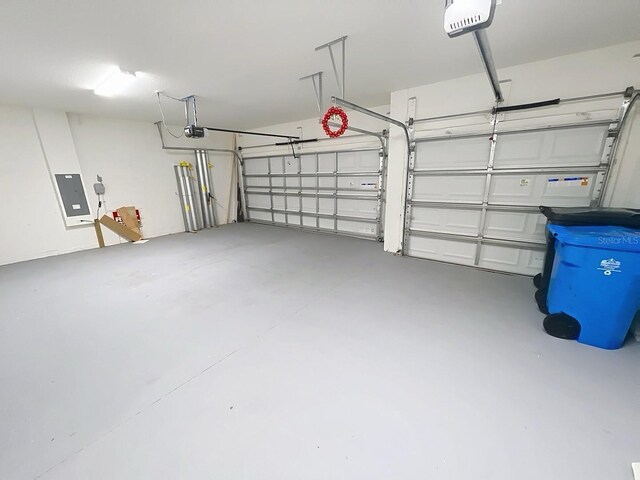 13014 Willow Grove Dr, Riverview, FL 33579 - garage featuring electric panel and a garage door opener