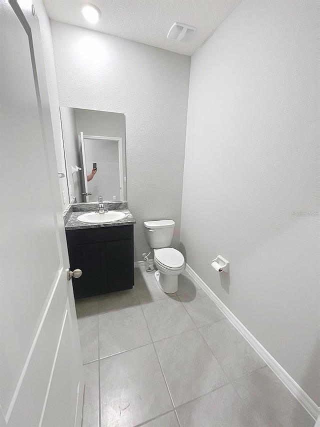 13014 Willow Grove Dr, Riverview, FL 33579 - bathroom featuring vanity, tile patterned flooring, toilet, a textured ceiling, and baseboards