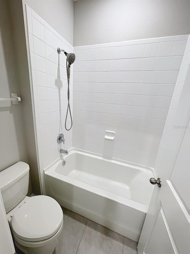 13014 Willow Grove Dr, Riverview, FL 33579 - bathroom featuring toilet, shower / bath combination, tile patterned floors, and a textured wall