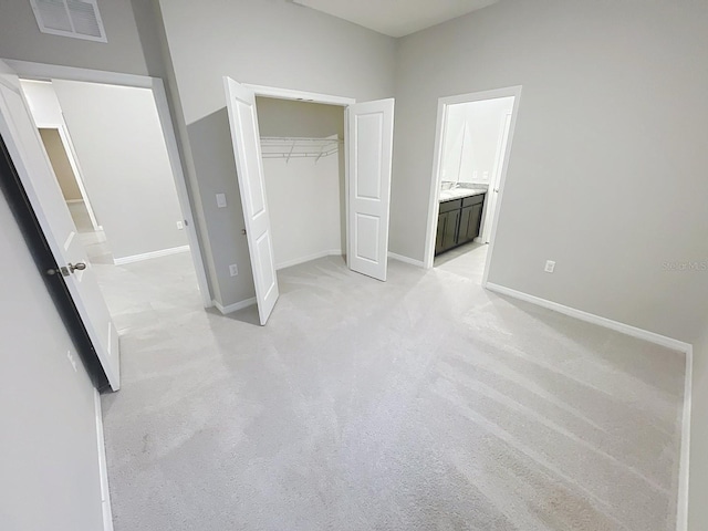 13014 Willow Grove Dr, Riverview, FL 33579 - unfurnished bedroom featuring light colored carpet, a closet, baseboards, and ensuite bath