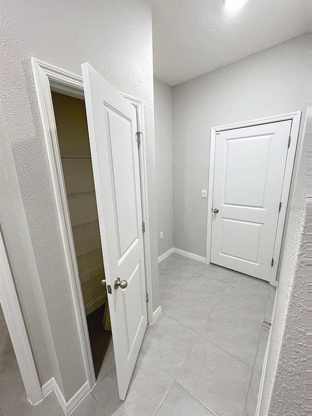 13014 Willow Grove Dr, Riverview, FL 33579 - hall with light tile patterned flooring, baseboards, and a textured wall