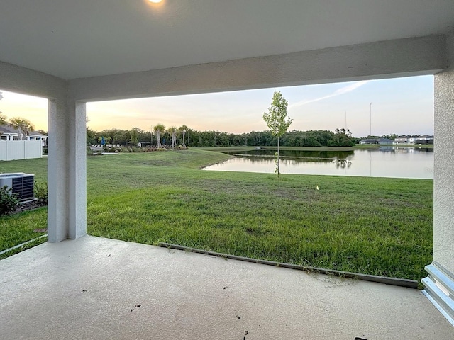 13014 Willow Grove Dr, Riverview, FL 33579 - yard at dusk featuring a water view, central air condition unit, a yard, and a patio area