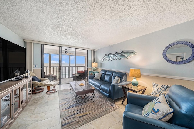 14900 Gulf Blvd Unit 308, Madeira Beach, FL 33708 - living room with a textured ceiling, expansive windows, a water view, and tile patterned floors