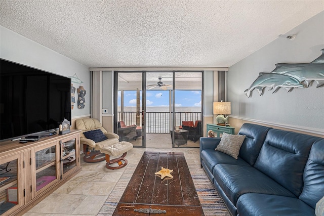 14900 Gulf Blvd Unit 308, Madeira Beach, FL 33708 - living room featuring a textured ceiling and a ceiling fan