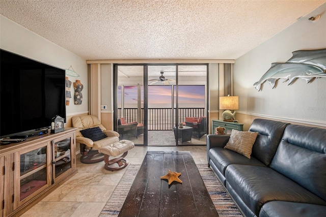 14900 Gulf Blvd Unit 308, Madeira Beach, FL 33708 - living area featuring a textured ceiling and a ceiling fan