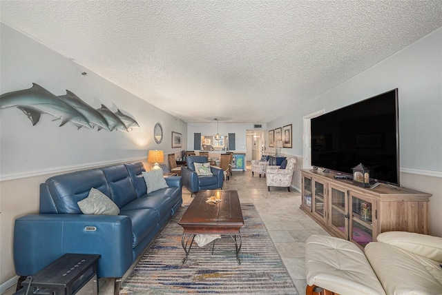 14900 Gulf Blvd Unit 308, Madeira Beach, FL 33708 - living area with a textured ceiling and light stone finish flooring
