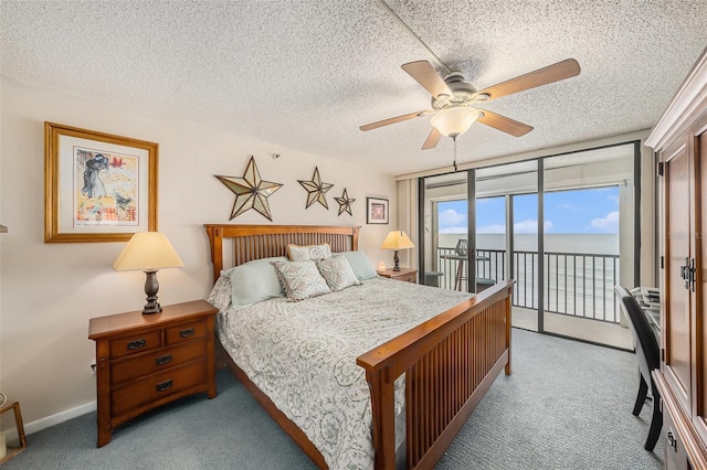 14900 Gulf Blvd Unit 308, Madeira Beach, FL 33708 - carpeted bedroom with access to outside, a water view, expansive windows, a ceiling fan, and a textured ceiling