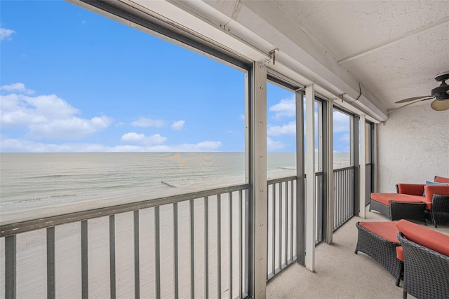 14900 Gulf Blvd Unit 308, Madeira Beach, FL 33708 - sunroom / solarium featuring view of water and beach, carpet flooring, and a textured wall