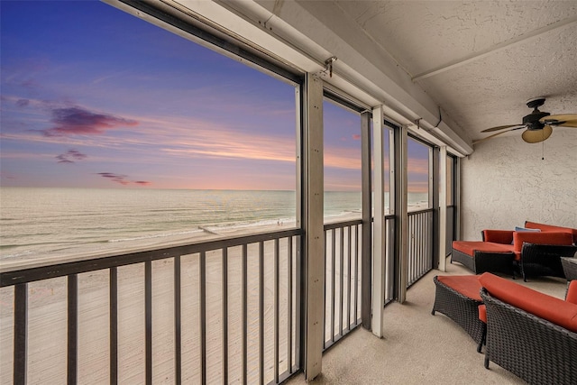 14900 Gulf Blvd Unit 308, Madeira Beach, FL 33708 - balcony at dusk featuring view of water and beach and a ceiling fan
