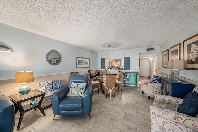 14900 Gulf Blvd Unit 308, Madeira Beach, FL 33708 - living room featuring a textured ceiling