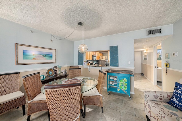 14900 Gulf Blvd Unit 308, Madeira Beach, FL 33708 - dining space with a textured ceiling