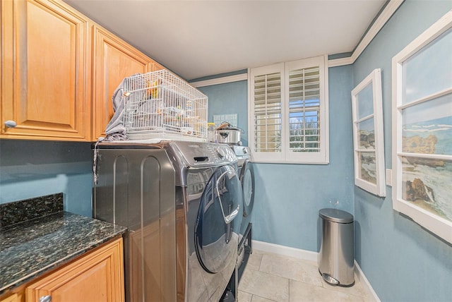 14900 Gulf Blvd Unit 308, Madeira Beach, FL 33708 - washroom with cabinet space, baseboards, light tile patterned floors, and washing machine and dryer