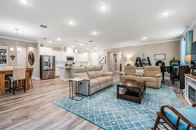 5 Sweetgum Ct N, Homosassa, FL 34446 - living room featuring ornamental molding, light wood finished floors, recessed lighting, and baseboards