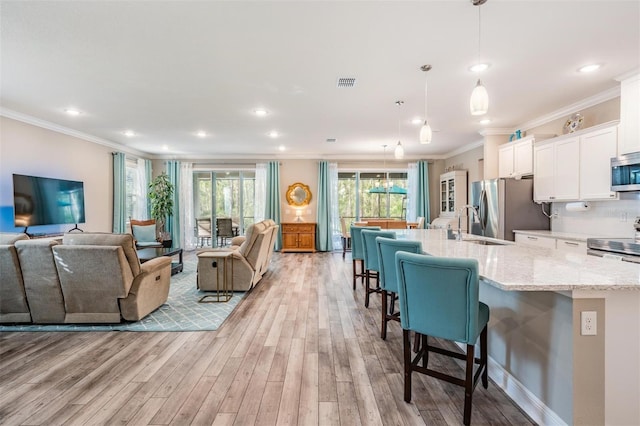 5 Sweetgum Ct N, Homosassa, FL 34446 - living room with light wood-style floors, ornamental molding, and recessed lighting