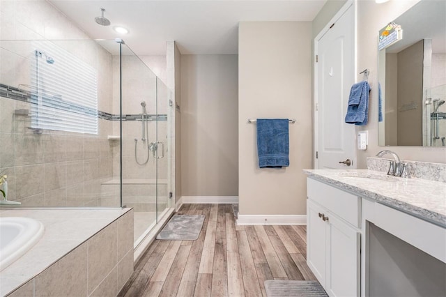 5 Sweetgum Ct N, Homosassa, FL 34446 - bathroom featuring a shower stall, vanity, baseboards, a bath, and wood finished floors