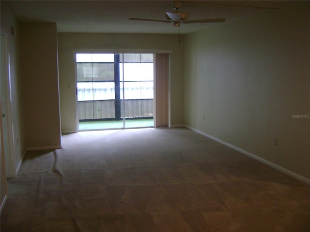 3077 Casa Del Sol Cir Unit 207, Clearwater, FL 33761 - empty room with ceiling fan, baseboards, and carpet flooring