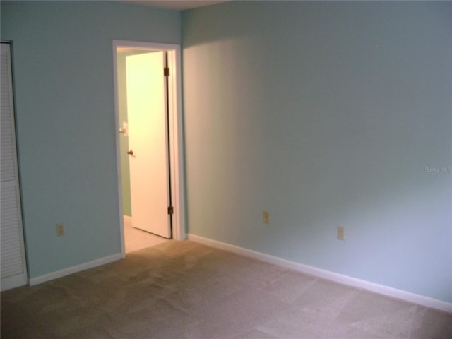 3077 Casa Del Sol Cir Unit 207, Clearwater, FL 33761 - empty room with light carpet and baseboards