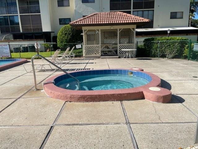 3077 Casa Del Sol Cir Unit 207, Clearwater, FL 33761 - view of pool with a community hot tub and a patio area