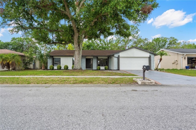 4706 Fox Hunt Dr, Tampa, FL 33624 - view of front facade featuring concrete driveway, an attached garage, and a front yard