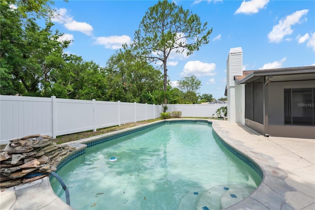 4706 Fox Hunt Dr, Tampa, FL 33624 - view of swimming pool with a fenced backyard, a sunroom, and a patio