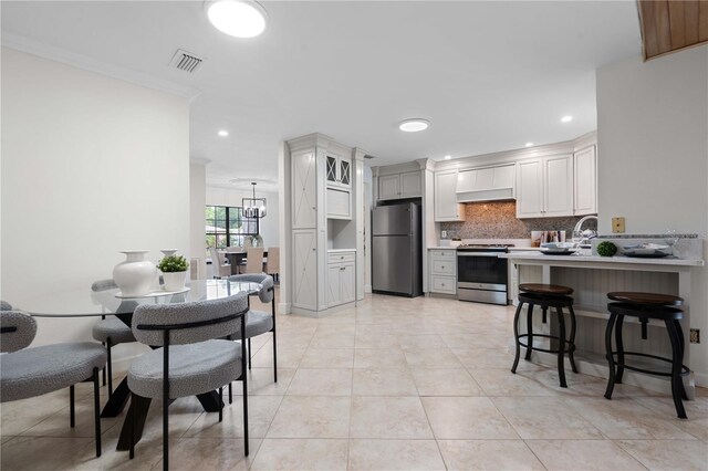 4706 Fox Hunt Dr, Tampa, FL 33624 - dining space featuring light tile patterned flooring, recessed lighting, ornamental molding, and a chandelier