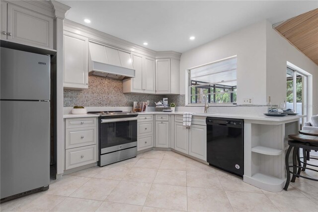 4706 Fox Hunt Dr, Tampa, FL 33624 - kitchen featuring stainless steel appliances, custom exhaust hood, light countertops, tasteful backsplash, and open shelves