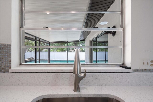 4706 Fox Hunt Dr, Tampa, FL 33624 - kitchen view of a sink and light stone countertops