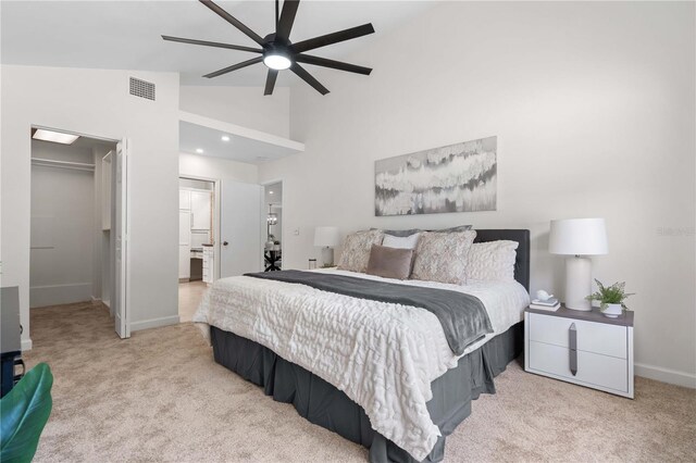 4706 Fox Hunt Dr, Tampa, FL 33624 - bedroom featuring carpet floors, a walk in closet, baseboards, high vaulted ceiling, and ensuite bath
