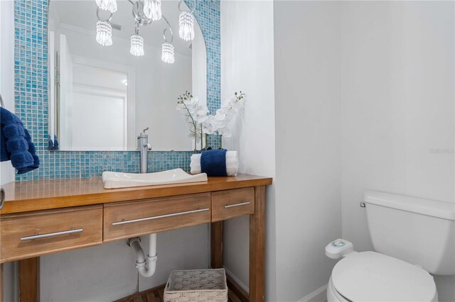 4706 Fox Hunt Dr, Tampa, FL 33624 - bathroom featuring vanity, toilet, and backsplash