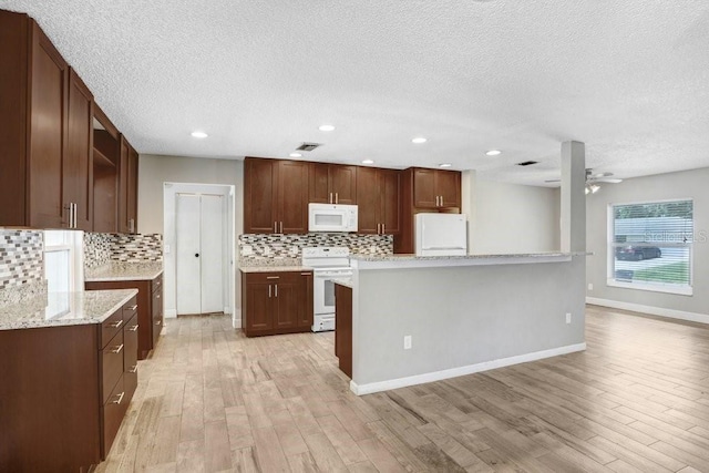 3917 Casaba Loop, Valrico, FL 33596 - kitchen with white appliances, a textured ceiling, decorative backsplash, a ceiling fan, and light wood-type flooring