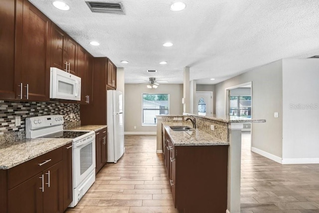 3917 Casaba Loop, Valrico, FL 33596 - kitchen featuring white appliances, a sink, baseboards, decorative backsplash, and a textured ceiling