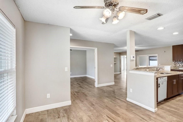 3917 Casaba Loop, Valrico, FL 33596 - kitchen with white dishwasher, a ceiling fan, light wood-type flooring, baseboards, and a textured ceiling