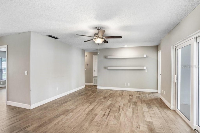 3917 Casaba Loop, Valrico, FL 33596 - unfurnished living room with a textured ceiling, light wood-style floors, ceiling fan, and baseboards