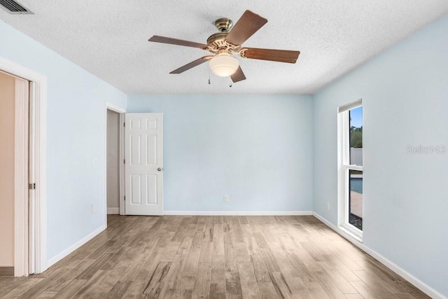 3917 Casaba Loop, Valrico, FL 33596 - unfurnished room featuring wood finished floors, a textured ceiling, baseboards, and ceiling fan