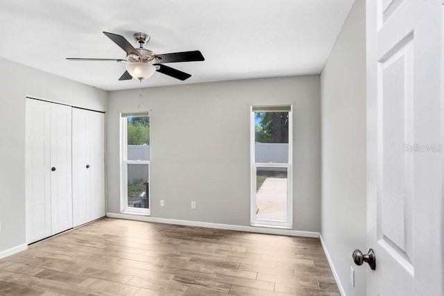 3917 Casaba Loop, Valrico, FL 33596 - unfurnished bedroom with wood finished floors, baseboards, a closet, and a ceiling fan