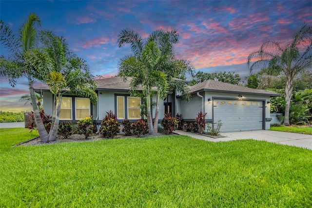 2016 Chelam Way, Brandon, FL 33511 - ranch-style home with stucco siding, an attached garage, driveway, and a yard
