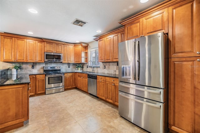 2016 Chelam Way, Brandon, FL 33511 - kitchen featuring stainless steel appliances, brown cabinetry, backsplash, a sink, and recessed lighting
