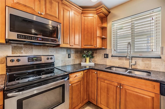 2016 Chelam Way, Brandon, FL 33511 - kitchen featuring appliances with stainless steel finishes, a sink, tasteful backsplash, dark stone countertops, and brown cabinets