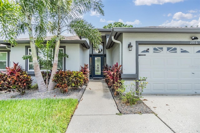 2016 Chelam Way, Brandon, FL 33511 - property entrance featuring stucco siding, an attached garage, and concrete driveway