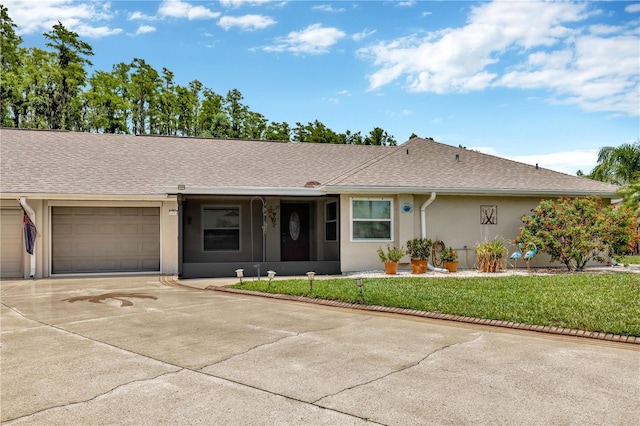1604 Comfy Ct, Sun City Center, FL 33573 - ranch-style house with a garage, concrete driveway, stucco siding, a front yard, and roof with shingles