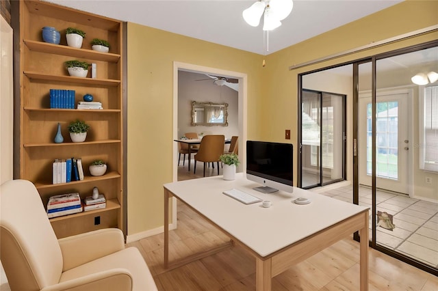 1604 Comfy Ct, Sun City Center, FL 33573 - office area with a ceiling fan, built in shelves, and baseboards