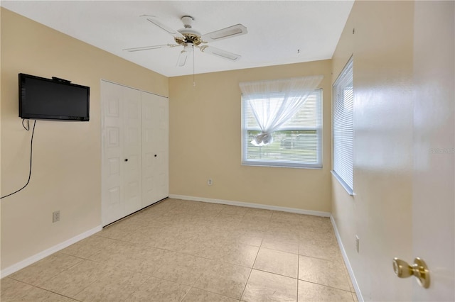 1604 Comfy Ct, Sun City Center, FL 33573 - unfurnished bedroom with light tile patterned floors, a closet, baseboards, and ceiling fan