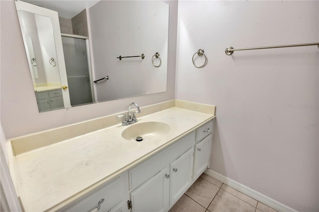 1604 Comfy Ct, Sun City Center, FL 33573 - bathroom with vanity, tile patterned flooring, a shower stall, and baseboards