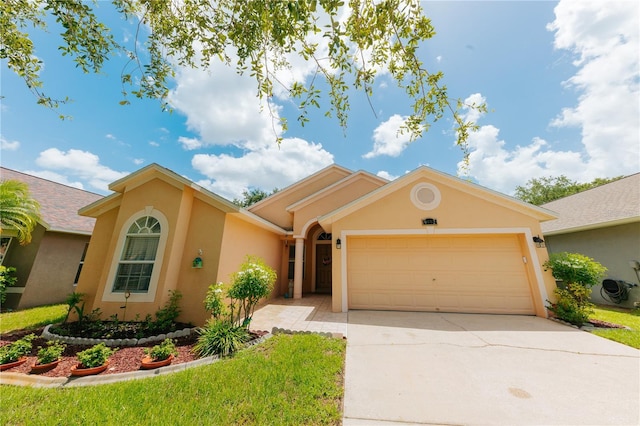 9852 Laurel Ledge Dr, Riverview, FL 33569 - view of front of home with stucco siding, a garage, and concrete driveway