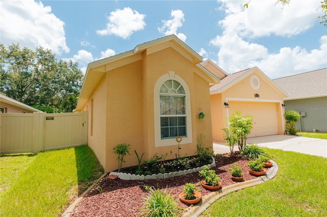 9852 Laurel Ledge Dr, Riverview, FL 33569 - view of front of home with stucco siding, driveway, and a garage