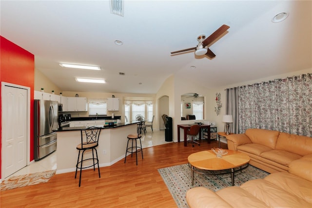 9852 Laurel Ledge Dr, Riverview, FL 33569 - living area featuring a ceiling fan, lofted ceiling, light wood-style flooring, recessed lighting, and arched walkways