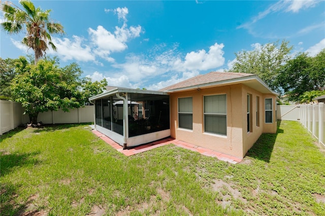 9852 Laurel Ledge Dr, Riverview, FL 33569 - rear view of property featuring a sunroom, a fenced backyard, and stucco siding