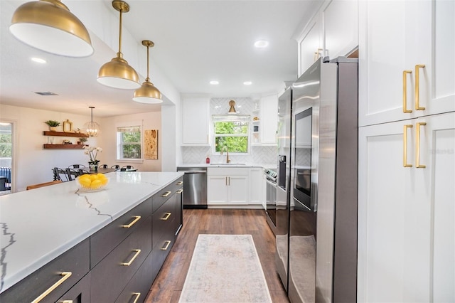 3120 S Polk Ave, Lakeland, FL 33803 - kitchen with appliances with stainless steel finishes, white cabinetry, healthy amount of natural light, dark wood-type flooring, and recessed lighting