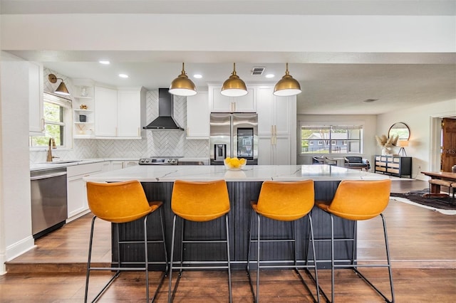3120 S Polk Ave, Lakeland, FL 33803 - kitchen with stainless steel appliances, wall chimney exhaust hood, a sink, open shelves, and decorative backsplash